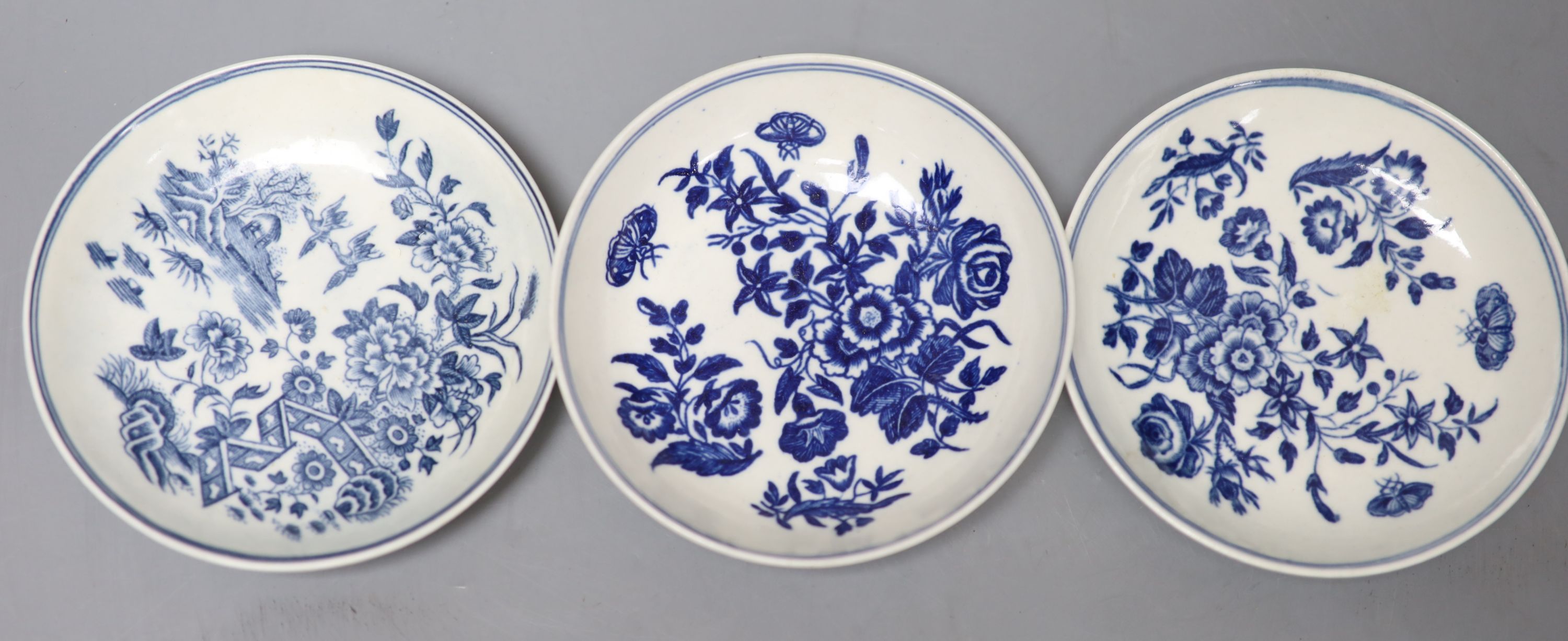 Three 18th century Worcester tea bowls and saucers, two printed with Three Flowers and one printed with the Fence pattern most with cre